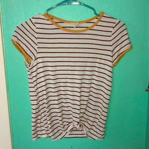 A black and whit stop shirt with some yellow.